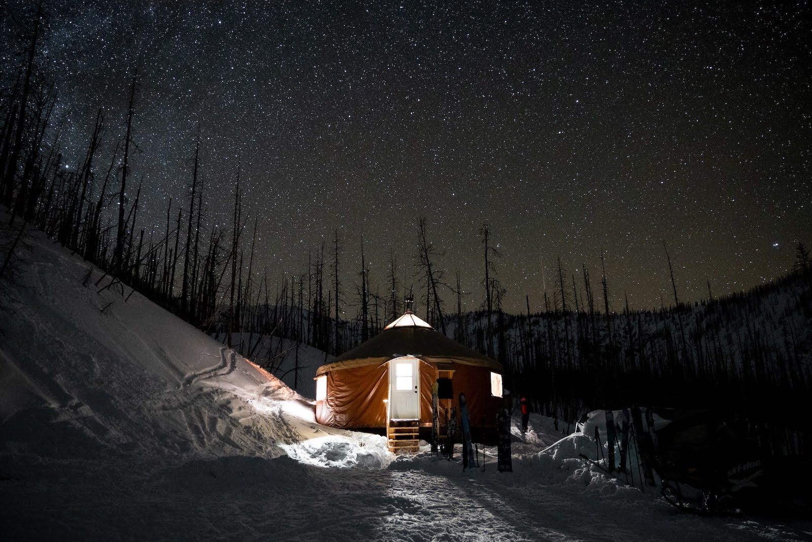 Alpine Yurt exterior at night under a clear sky full of stars